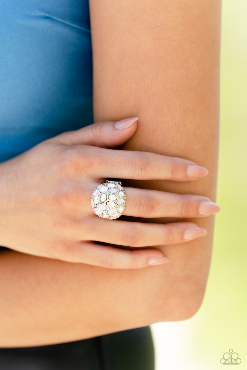 BLING Loud and Proud - White Iridescent Ring - Paparazzi Accessories - A studded silver frame, filled with blinding oval-cut gems in opalescent, white, and iridescent shades, stands out atop the finger for a blingy statement. Features a stretchy band for a flexible fit.