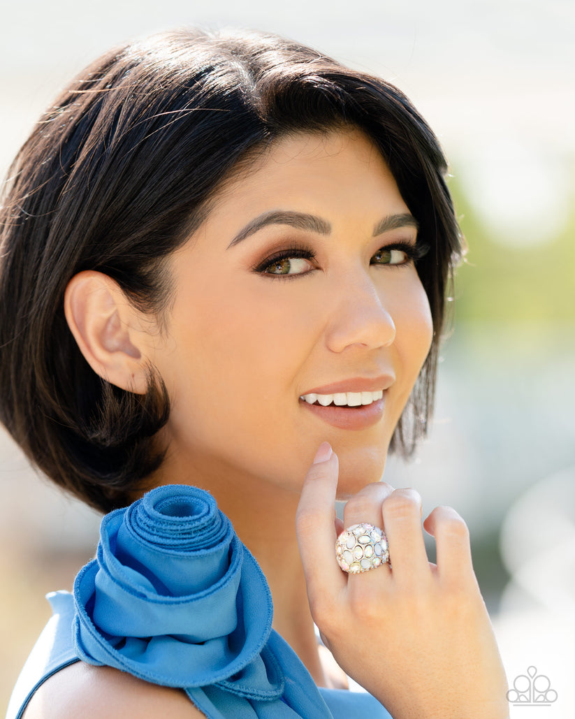 BLING Loud and Proud - White Iridescent Ring - Paparazzi Accessories - A studded silver frame, filled with blinding oval-cut gems in opalescent, white, and iridescent shades, stands out atop the finger for a blingy statement. Features a stretchy band for a flexible fit.