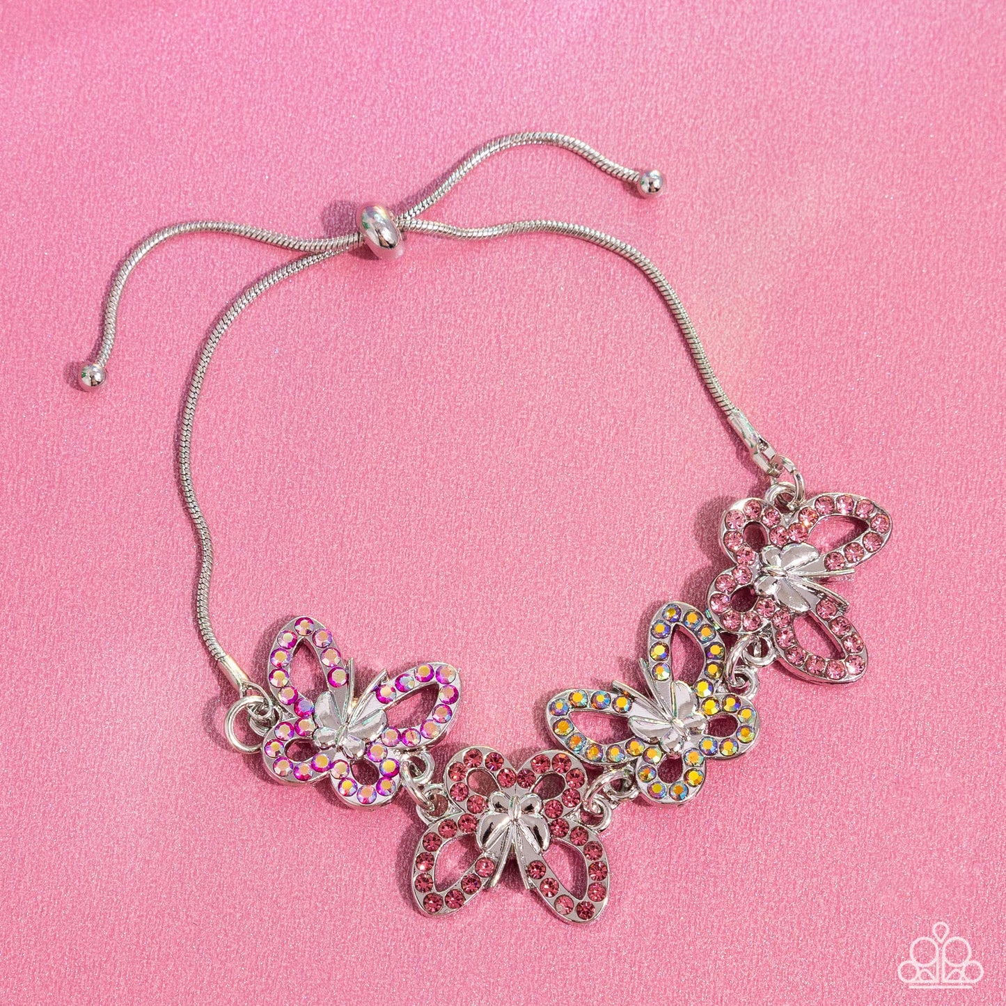 Butterfly Belonging - Pink Bracelet - Paparazzi Accessories - Attached to a silver snake chain, a whimsical collection of multicolored pink and iridescent-dotted silver butterflies flutter along the wrist.