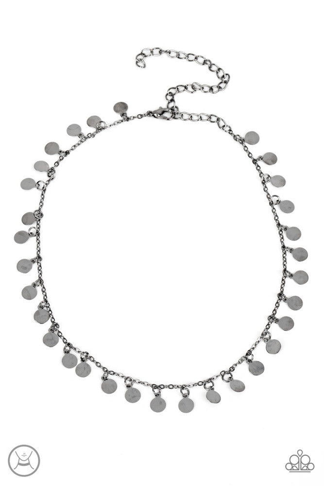Champagne Catwalk - Black Choker Necklace - Paparazzi Accessories - Tiny gunmetal discs dance along a classic gunmetal chain, creating an understated choker necklace. The reflective surfaces of the discs shimmer brightly, as the light catches their high sheen finish to exaggerate their intensity.