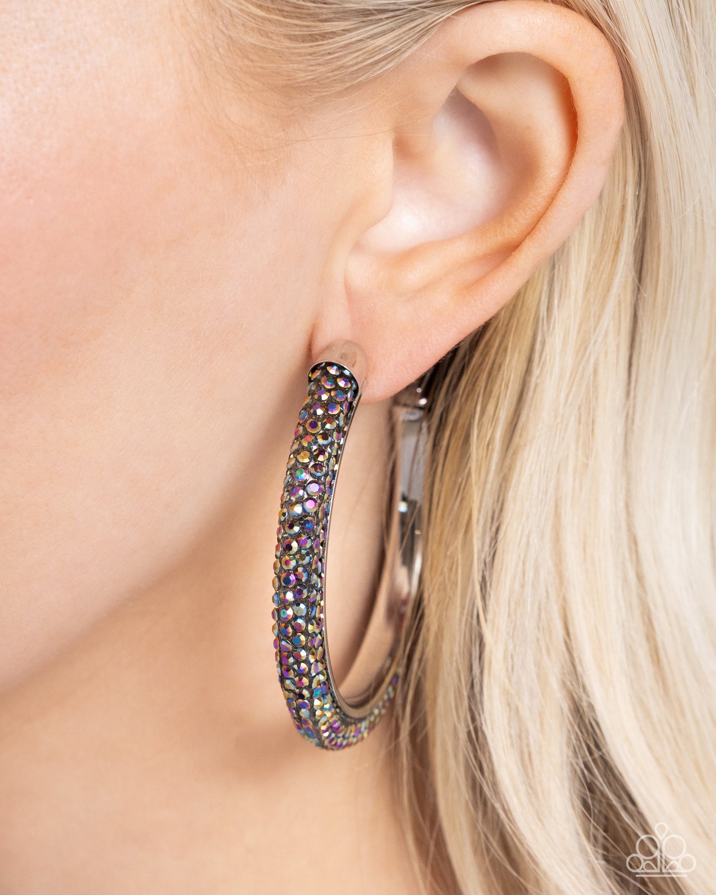 Chiseled Crescendo - Multi Color - Oil Spill Earrings - Paparazzi Accessories - Embellished along the curve of a silver-capped hoop, mesmerizing oil spill rhinestones flicker and flash along the ear for a chiseled confident look. Earring attaches to a standard post fitting. Hoop measures approximately 2 1/2" in diameter. Sold as one pair of hoop earrings.
