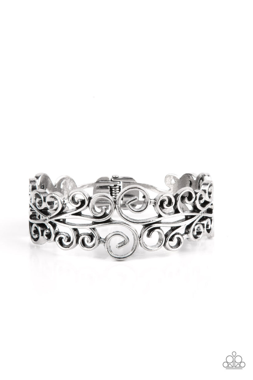 Dressed to FRILL - Silver Bracelet - Paparazzi Accessories - Frilly silver vine-like filigree scrolls around the wrist, coalescing into a whimsical bangle-like bracelet. Features a hinged closure. Sold as one individual bracelet.