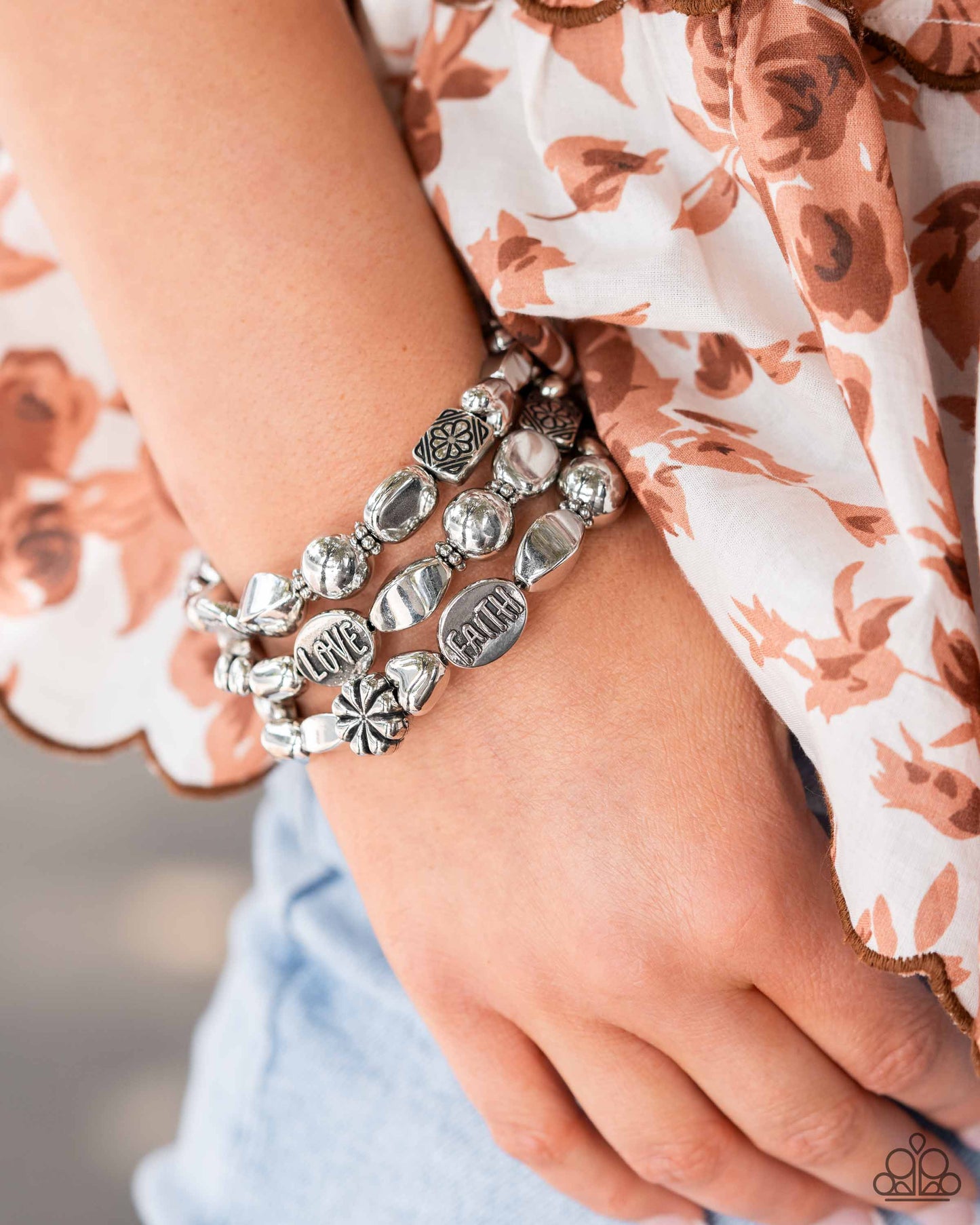Enchanting Emotion - Silver Infinity Bracelet - Paparazzi Accessories - An enchanting assortment of shiny silver, faceted, and floral embossed beads alternate along a coiled wire, creating a whimsical infinity-style bracelet around the wrist. Additional oval silver beads featuring the words "FAITH," "HOPE," "TRUTH," and "LOVE" finish off the design with an inspirational finish.