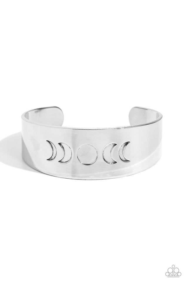 Lunar Effect - Silver Cuff Bracelet - Paparazzi Accessories - The phases of the moon are engraved across the front of a thick, shiny, silver cuff creating an effortlessly celestial statement piece.