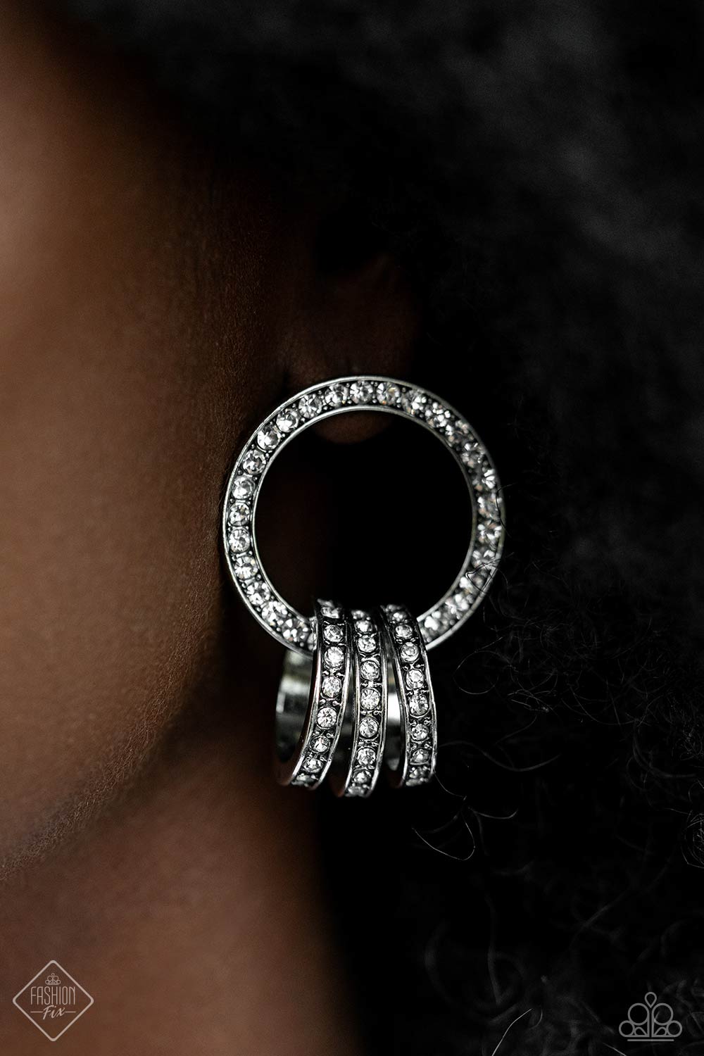 Magnificent Musings - Silver Jewelry Set - Paparazzi Accessories - A commanding collection of silver hoops, adorned in glitzy white rhinestones, coalesces into an interlocking hoop display, creating a brilliantly stacked lure. The larger hoop the three smaller hoops adorn is also framed in glitzy white rhinestones, emitting glitz and glam from every curve. Earring attaches to a standard post fitting. Sold as one pair of post earrings.