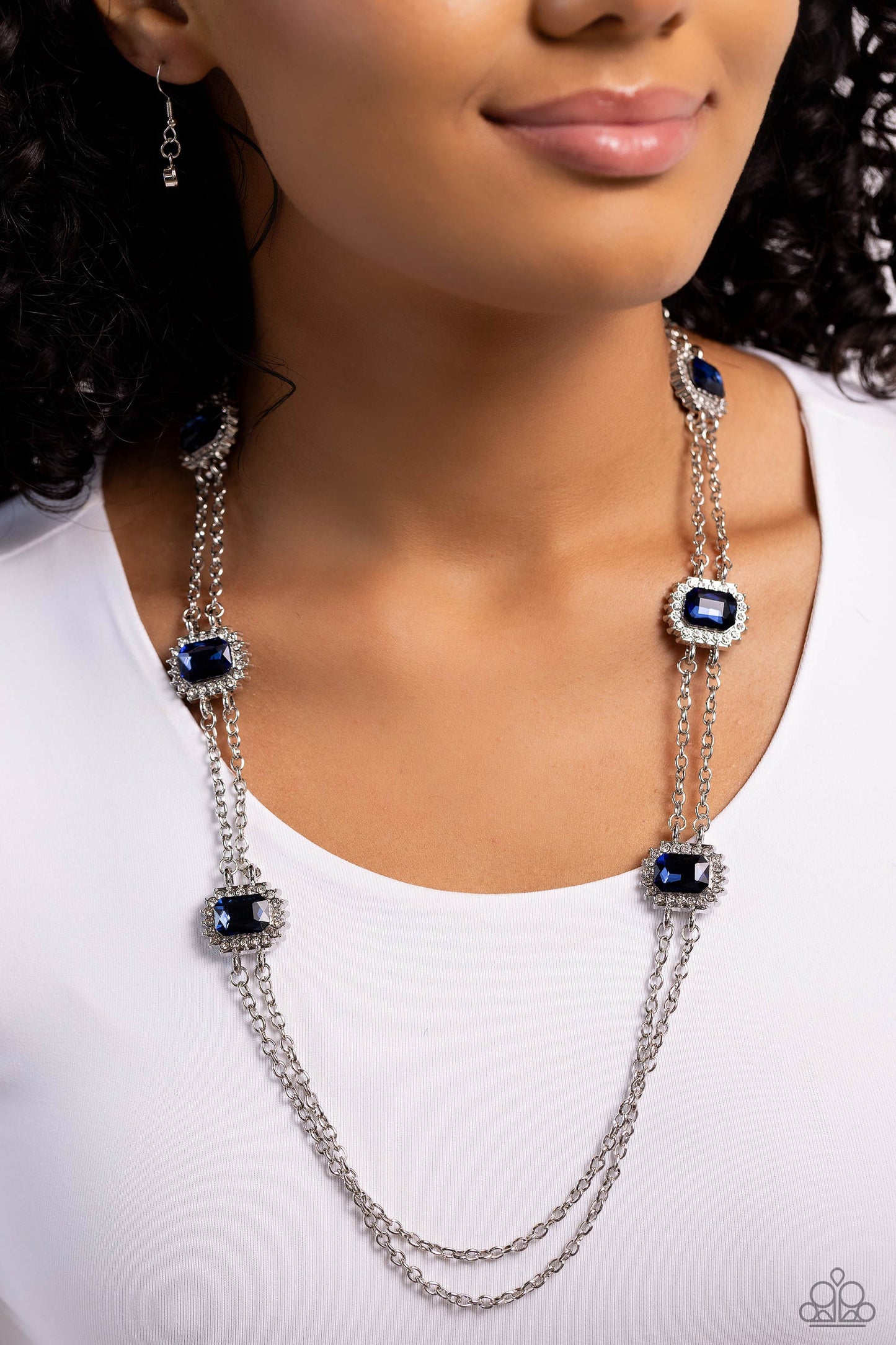 Pocketful of Sunshine - Blue and Silver Necklace - Paparazzi Accessories - Pressed in sunburst-like, rhinestone-encrusted pronged silver fittings, a collection of emerald-cut blue gems are infused between a double-strand of silver chains for a standout statement.