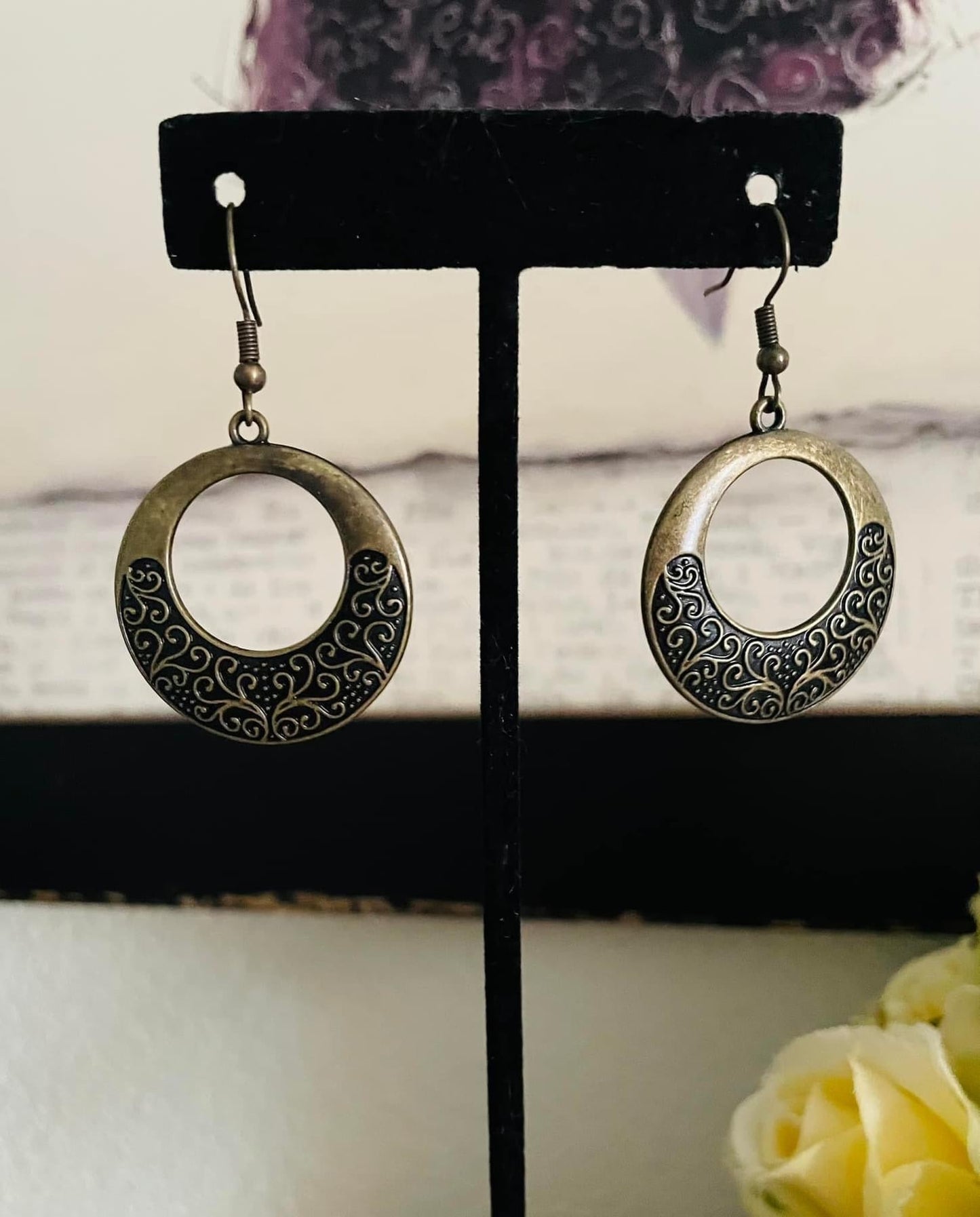 Secret Vineyards - Brass Earrings - Paparazzi Accessories - Infused with brass studs, frilly vine-like filigree whirls out across the bottom of a brass hoop for a seasonal shimmer. Earrings attaches to a standard fishhook fitting. Sold as one pair of earrings.