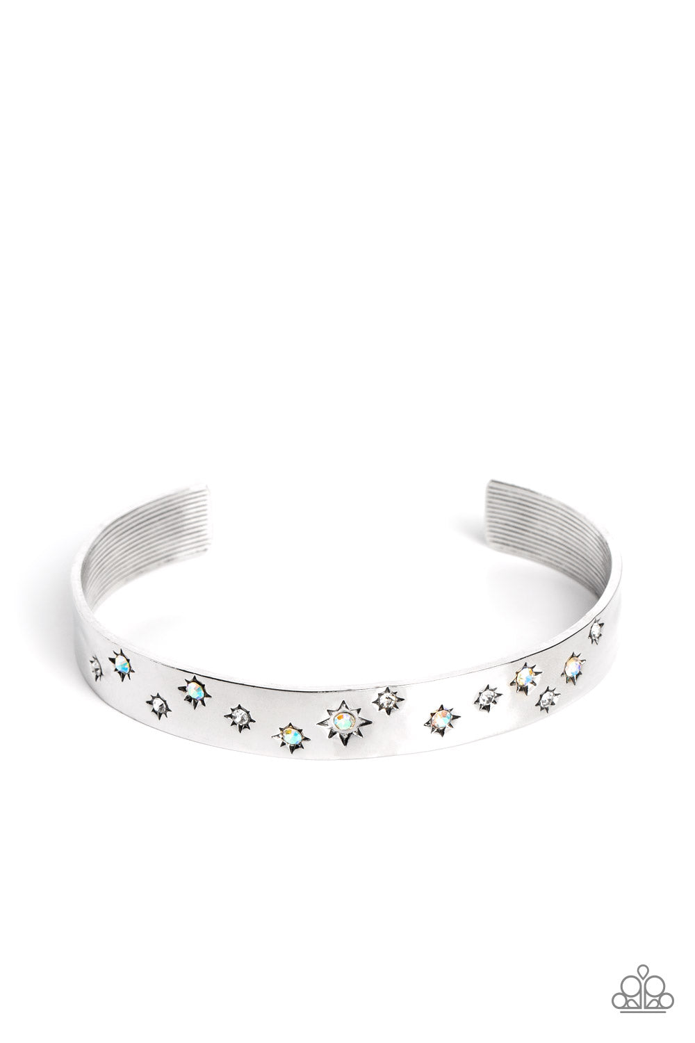 Starburst Shimmer - Iridescent and Silver Bracelet - Paparazzi Accessories - Tinted in subtle, stellar shades of white and iridescence, dainty rhinestones are pressed into the centers of stamped stars in varying sizes. Embossed in tactile textures, the starry collection wraps around the wrist against a backdrop of a high-sheen silver cuff, emitting further glow to the design.
