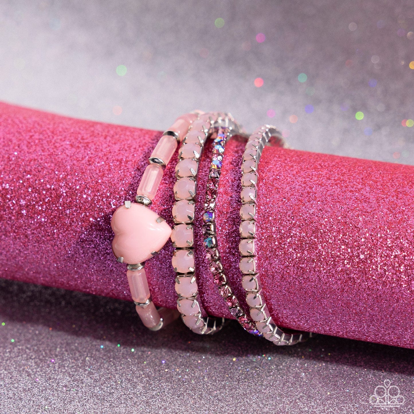"True Loves Theme - Pink Heart Bracelets - Paparazzi Accessories - Pronged in silver fittings, a Crystal Rose heart bracelet is infused along a milky Crystal Rose-beaded bracelet. Multicolored pink rhinestones and Crystal Rose beads are set in square box fittings creating a dramatic collision of color and shimmer."