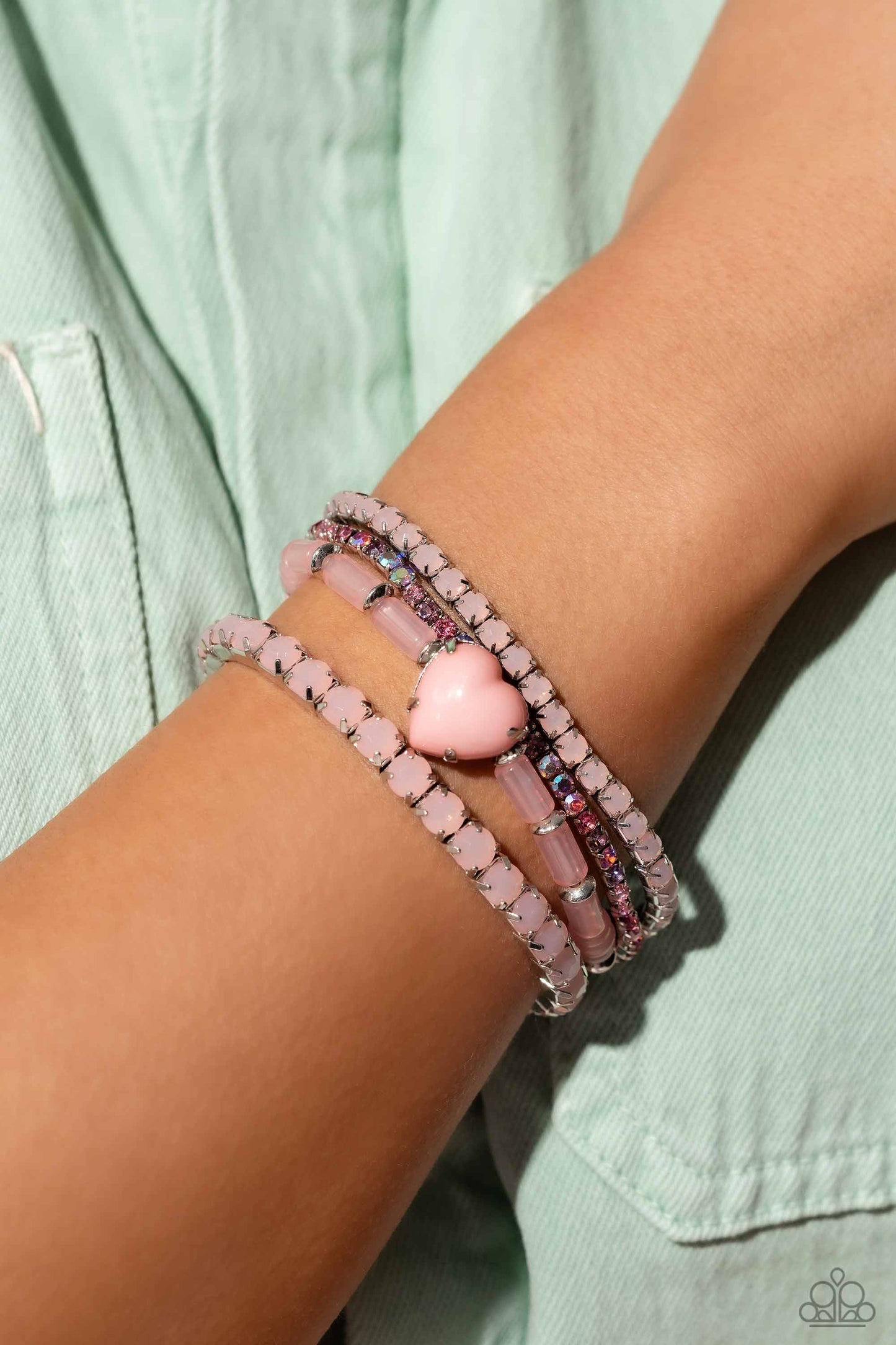 True Loves Theme - Pink Heart Bracelets - Paparazzi Accessories - Pronged in silver fittings, a Crystal Rose heart bracelet is infused along a milky Crystal Rose-beaded bracelet. Multicolored pink rhinestones and Crystal Rose beads are set in square box fittings creating a dramatic collision of color and shimmer.