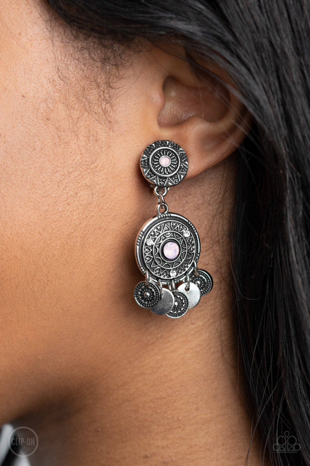A DREAMCATCHER Come True - Pink Floral - Silver Clip On Earrings - Paparazzi Accessories -
Dainty silver discs and antiqued floral frames dance from the bottom of an ornately embossed silver frame that links to a matching silver fitting. Both frames are dotted in pink opalescent rhinestone centers, while the largest of frames is sprinkled in dainty white rhinestone accents for a dreamy finish. Earring attaches to a standard clip-on fitting.