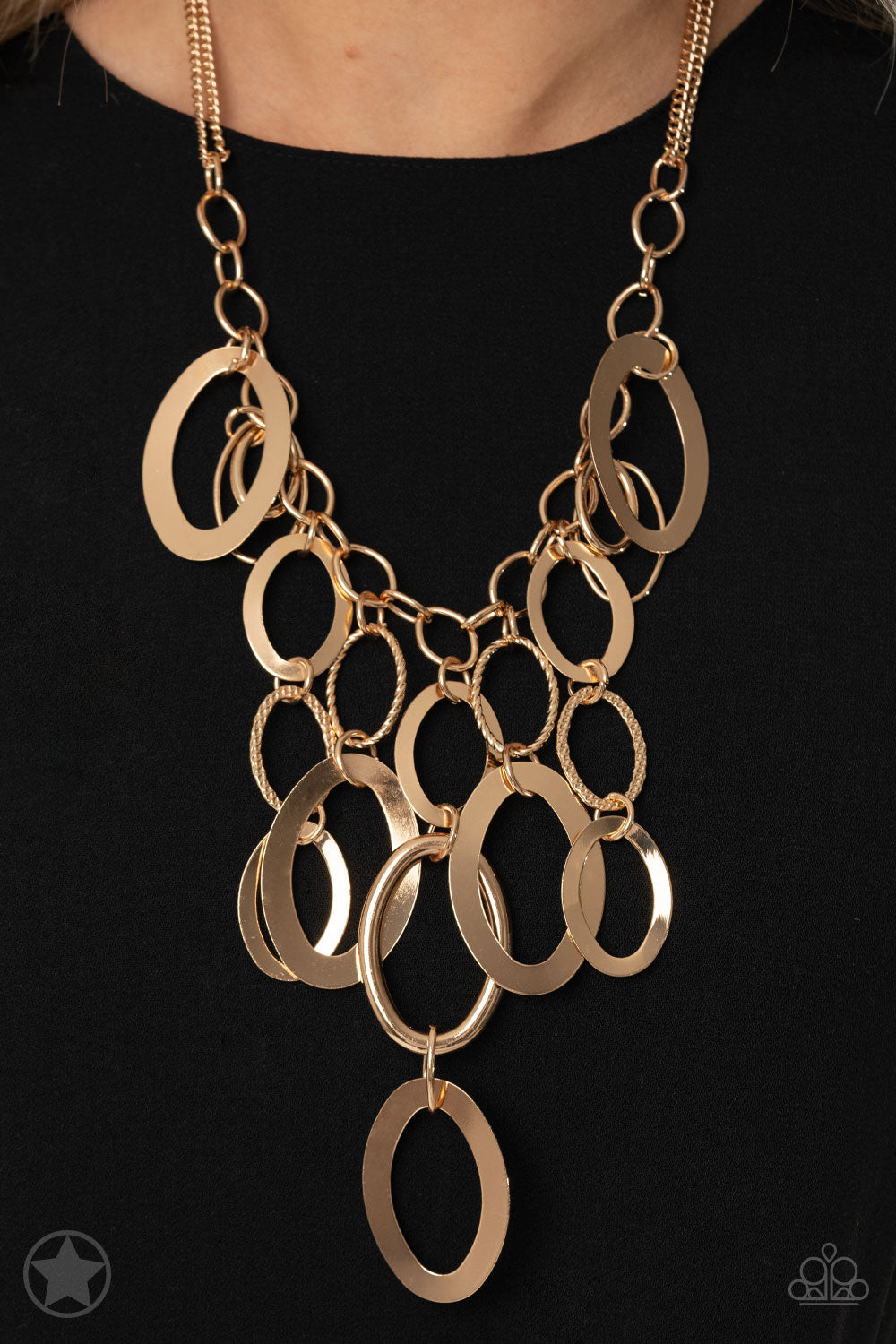 A Golden Spell - Gold Fashion Necklace - Paparazzi Accessories - Large gold links and shimmering textured gold rings cascade below a gold chain freely, allowing for movement that makes a bold statement.