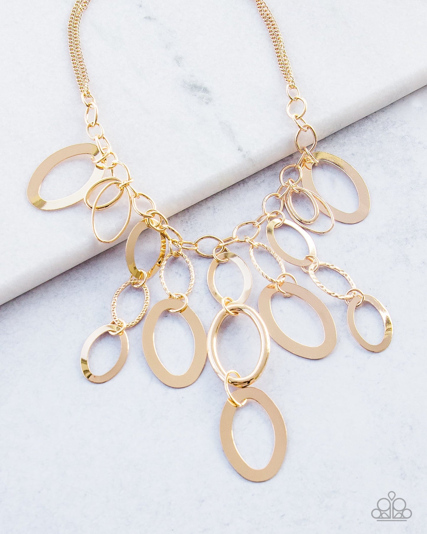 A Golden Spell - Gold Fashion Necklace - Paparazzi Accessories - Large gold links and shimmering textured gold rings cascade below a gold chain freely, allowing for movement that makes a bold statement.
