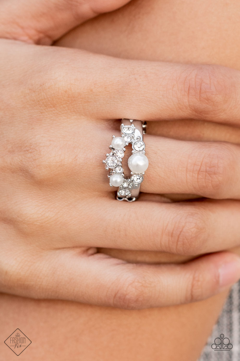 A-List Ambience - White Pearl - Silver Ring - Paparazzi Accessories - Silver with collection of white pearls and glassy white rhinestones coalesce into two effervescent bands across the finger. Features a dainty stretchy band for a flexible fit. Trendy fashion jewelry for everyone.