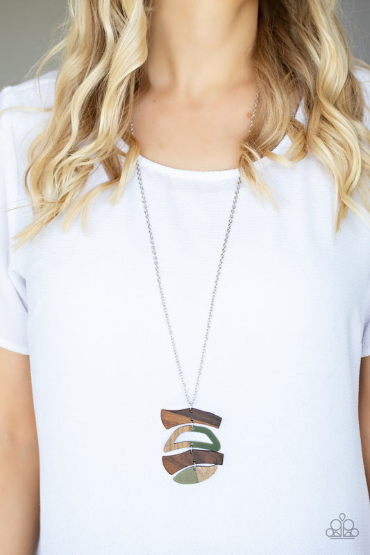A WOODWORK In Progress - Green - Brown Wood Necklace - Paparazzi Accessories -Featuring green acrylic accents, mismatched wooden frames delicately link into an abstract pendant at the bottom of a lengthened silver chain for an earthy fashion.