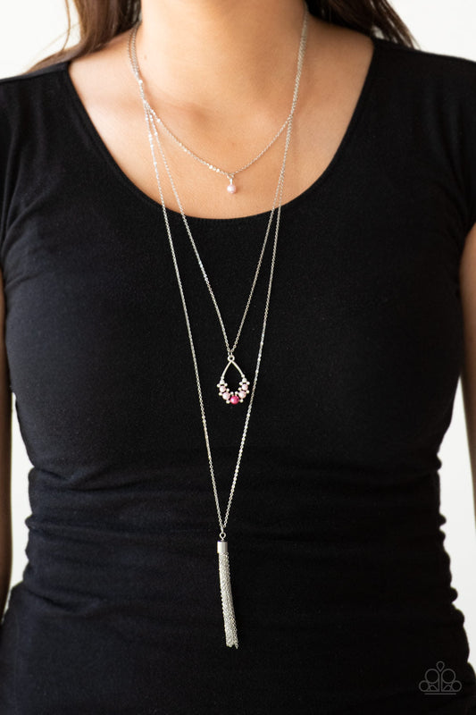 Be Fancy - Pink - Red and Silver Necklace - Paparazzi Accessories - A solitaire pink pearl swings from the uppermost chain, giving way to a teardrop pendant and shimmery silver chain tassel. Dainty white rhinestones and pink pearls collect at the bottom of the centermost pendant for a glamorous finish.