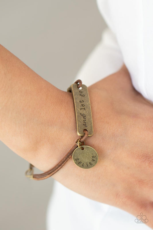 Believe and Let Go - Brass Suede Bracelet - Paparazzi Accessories - 
An antiqued disc stamped in the word, "believe" and a brass plate stamped in the phrase, "and let go," are knotted in place around the wrist with layers of brown suede cording, creating a motivational centerpiece. Features an adjustable clasp closure. Sold as one individual bracelet.