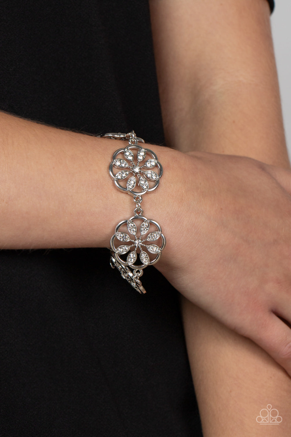 Blooming Bling - White Rhinestone Floral - Sparkly Silver Bracelet - Paparazzi Accessories - White rhinestone floral accents, scalloped silver frames delicately link around the wrist for a sparkly seasonal fashion. Features an adjustable clasp closure fashion bracelet.
