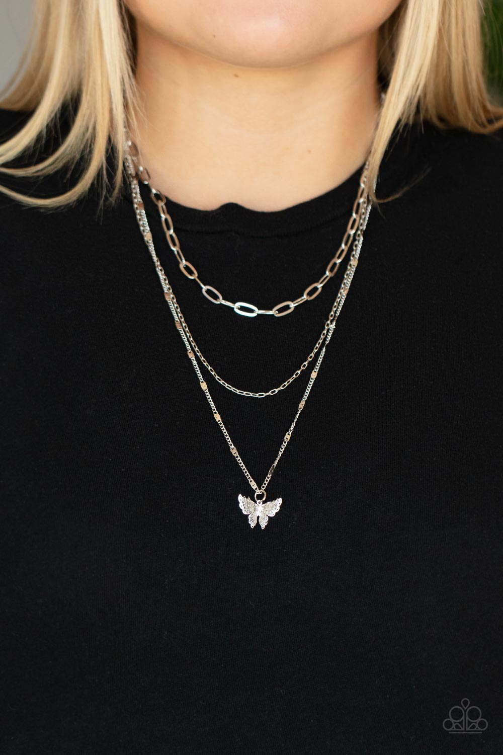 Bountiful Butterflies - Silver Butterfly Fashion Necklace - Paparazzi Accessories - Dotted with a dainty white rhinestone, a decoratively layered silver butterfly swings from the bottom of a display of mismatched silver chains for a whimsically fluttering fashion necklace.