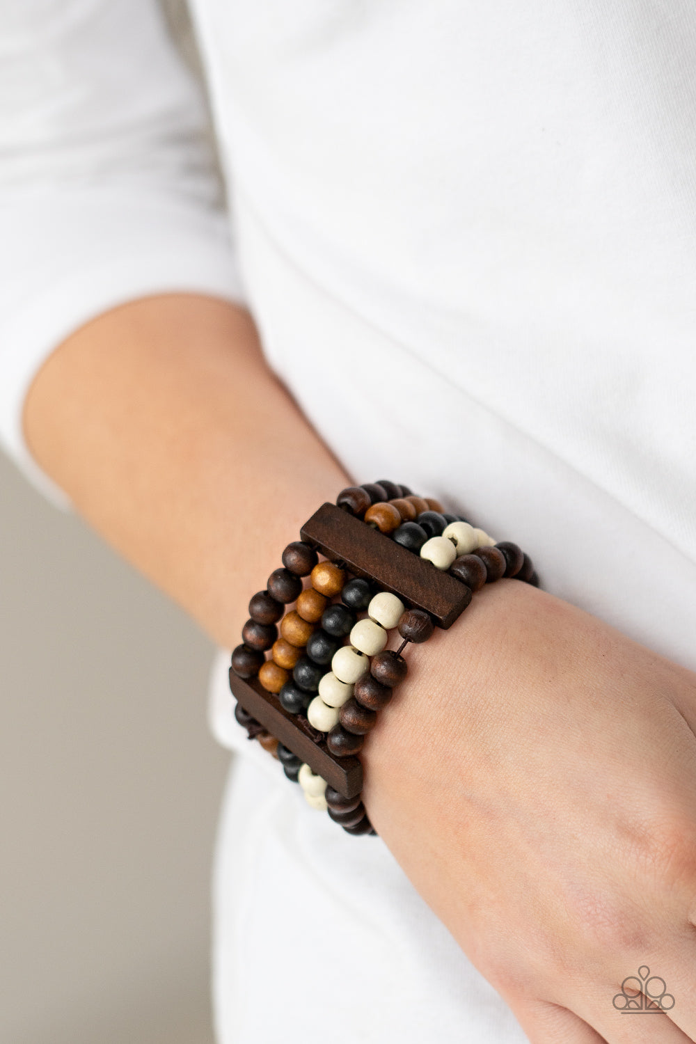 Caribbean Catwalk - Brown - Black - White Wood Stretchy Bracelet - Paparazzi Accessories -
Held in place by rectangular wooden frames, strands of brown, black, and white wooden beads are threaded along stretchy bands around the wrist for a colorfully tropical look. Sold as one individual bracelet.
