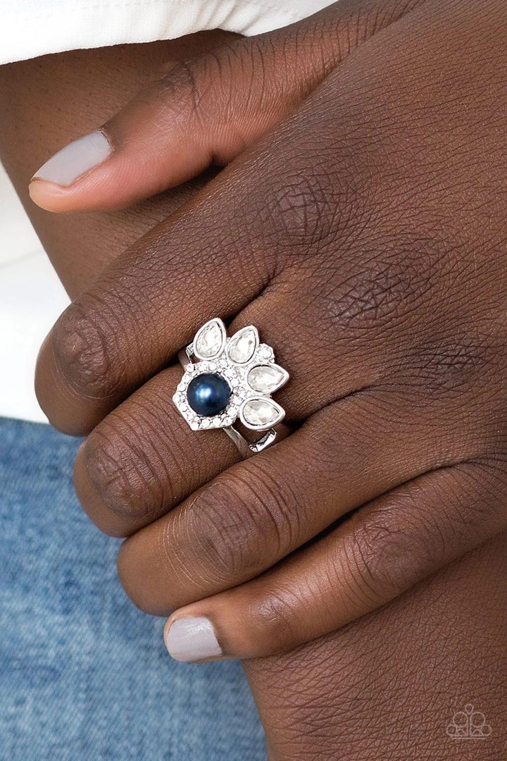 Crown Coronation - Blue - Silver Ring - Paparazzi Accessories - glittery white rhinestones flare from the center of a blue pearl drop center. Dainty white rhinestones spin around the pearly center for a glamorous finish. Features a stretchy band for a flexible fit. - Bejeweled Accessories By Kristie - Trendy fashion jewelry for everyone -