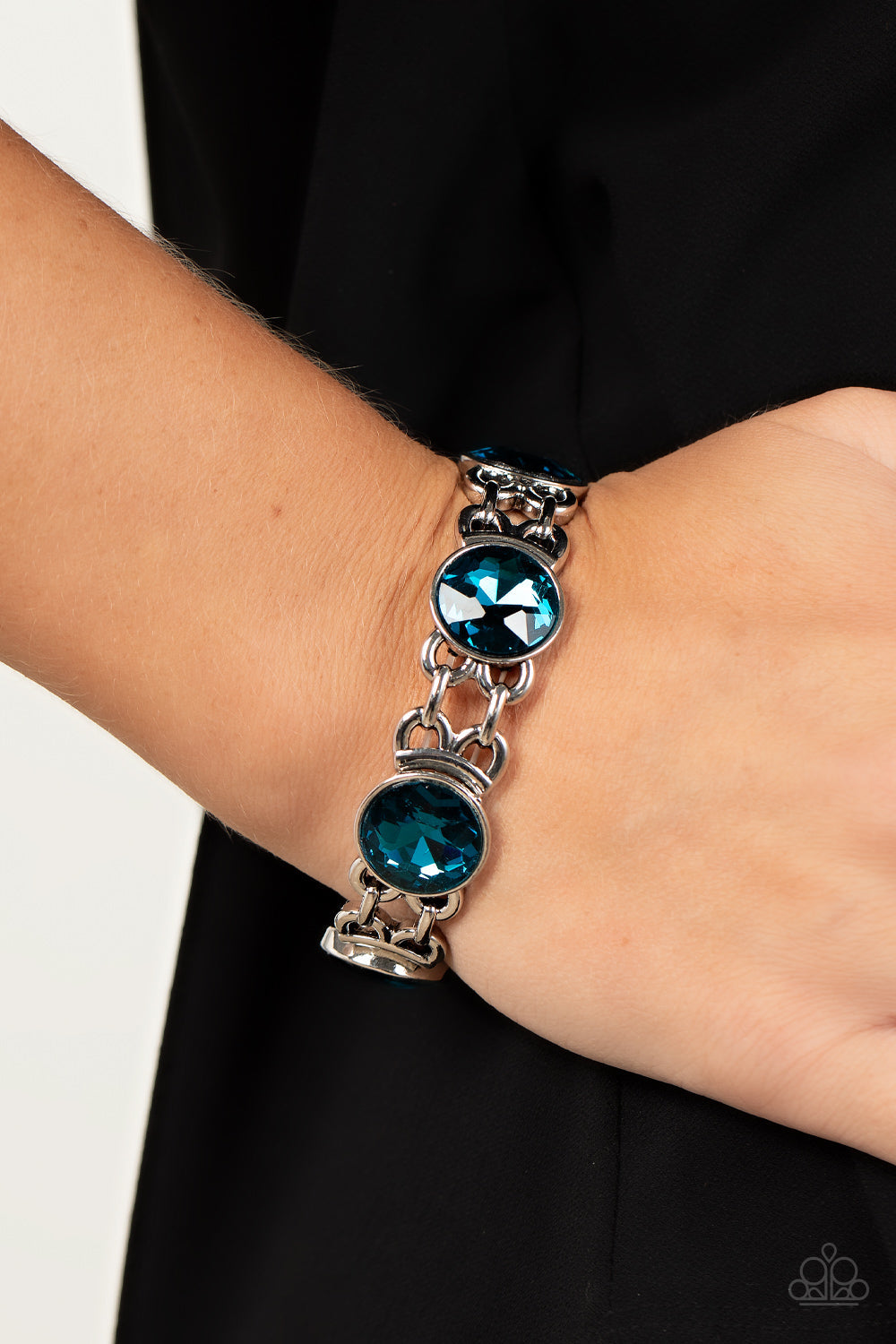 Devoted to Drama - Blue and Silver Stretchy Bracelet - Paparazzi Accessories -
Featuring edgy chain-like fittings, a sparkly series of oversized blue rhinestones are threaded along stretchy bands around the wrist for a dramatic pop of glitz.
Sold as one individual bracelet.