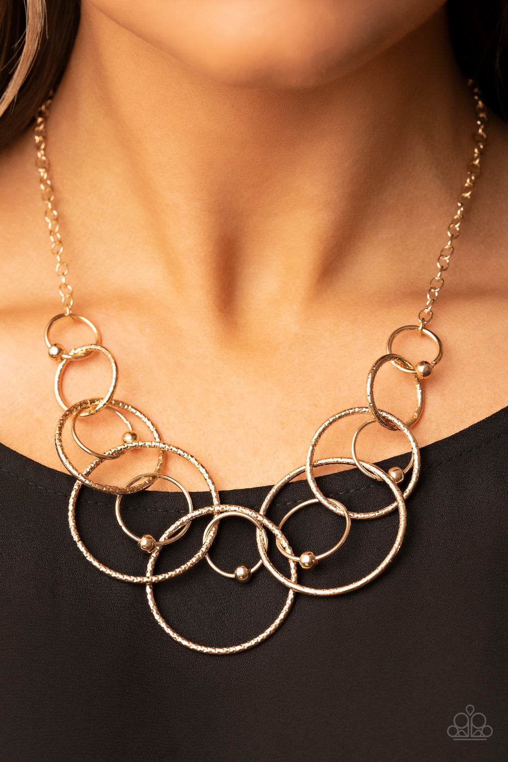 Encircled in Elegance - Gold Necklace - Paparazzi Accessories - Infused with dainty gold beads, shiny gold rings interlock with oversized and textured gold rings below the collar, resulting in a dizzying centerpiece necklace.