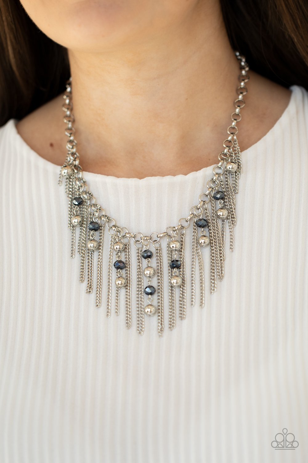 Ever Rebellious - Blue and Silver Necklace - Paparazzi Accessories - Glistening silver chains and strands of metallic blue crystal-like beads and glistening silver beads stream from the bottom of a bold silver chain, creating a sassy fringe below the collar. Features an adjustable clasp closure. Sold as one individual necklace.