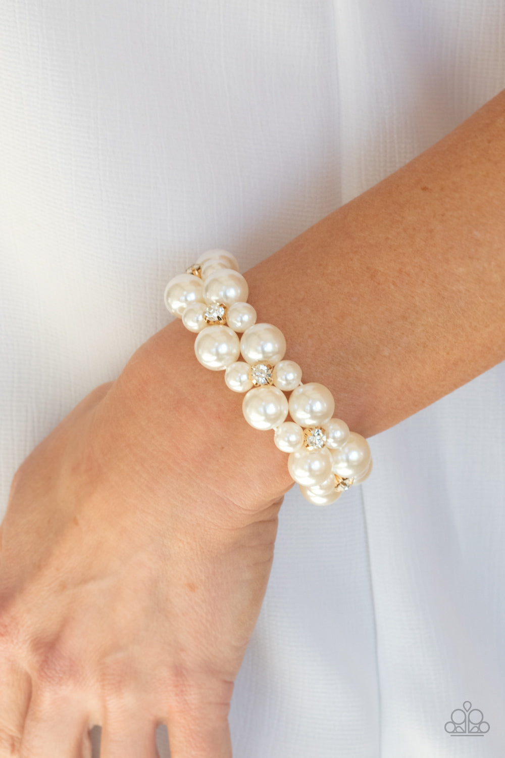 Flirt Alert - Gold and White Pearl - Stretchy Bracelet - Paparazzi Accessories - A bubbly collection of white pearls and classic white rhinestone encrusted gold frames are threaded along stretchy bands around the wrist, creating flirtatious refinement. Sold as one individual bracelet.