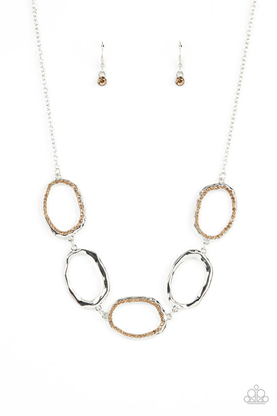 Gritty Go-Getter - Brown and Silver Necklace - Paparazzi Accessories - A row of dazzling light topaz rhinestones makes its way around a delicately hammered imperfect circular frame. The airy frames alternately link end to end with similar shiny silver frames creating a glitzy fashion across the collar. Features an adjustable clasp closure.