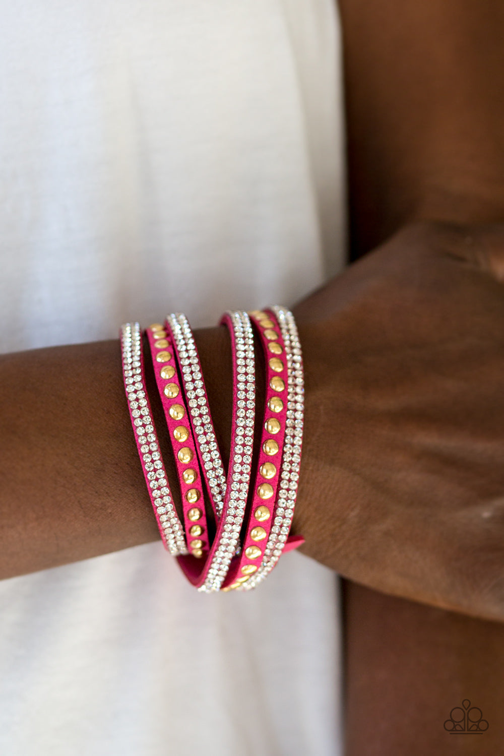 I BOLD You So! - Pink and Gold Wrap Bracelet - Paparazzi Accessories - Rows of glassy white rhinestones and glistening gold studs are pressed along three strands of pink suede for a sassy look. The elongated band allows for a trendy double wrap design. Features an adjustable snap closure. Sold as one individual bracelet.