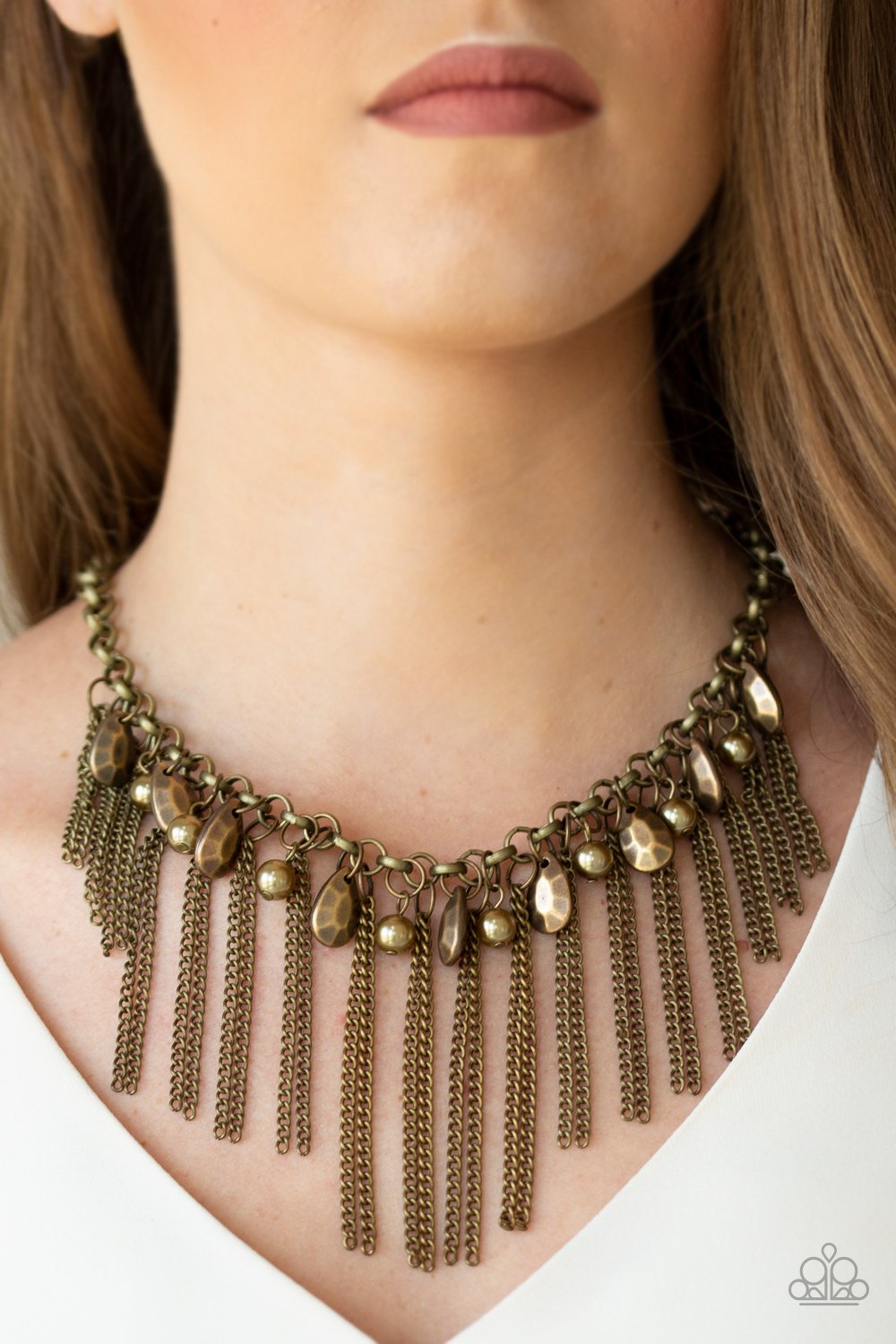 Industrial Intensity Brass Necklace - Paparazzi Accessories - A collection of faceted brass teardrops and pearly brass beads drip from the bottom of an antiqued brass chain. Pairs of brass chains stream from the bottom of the chain, creating an intensely tapered fringe below the collar. Features an adjustable clasp closure. Sold as one individual necklace.