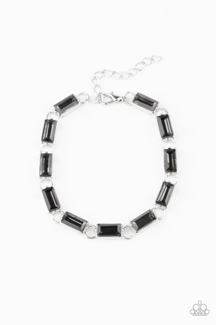 Irresistibly Icy - Smoky Silver Bracelet - Paparazzi Accessories -
Featuring sleek silver frames, a glittery collection of emerald cut smoky rhinestones delicately link across the wrist for a glamorous look. Features an adjustable clasp closure. Sold as one individual bracelet.