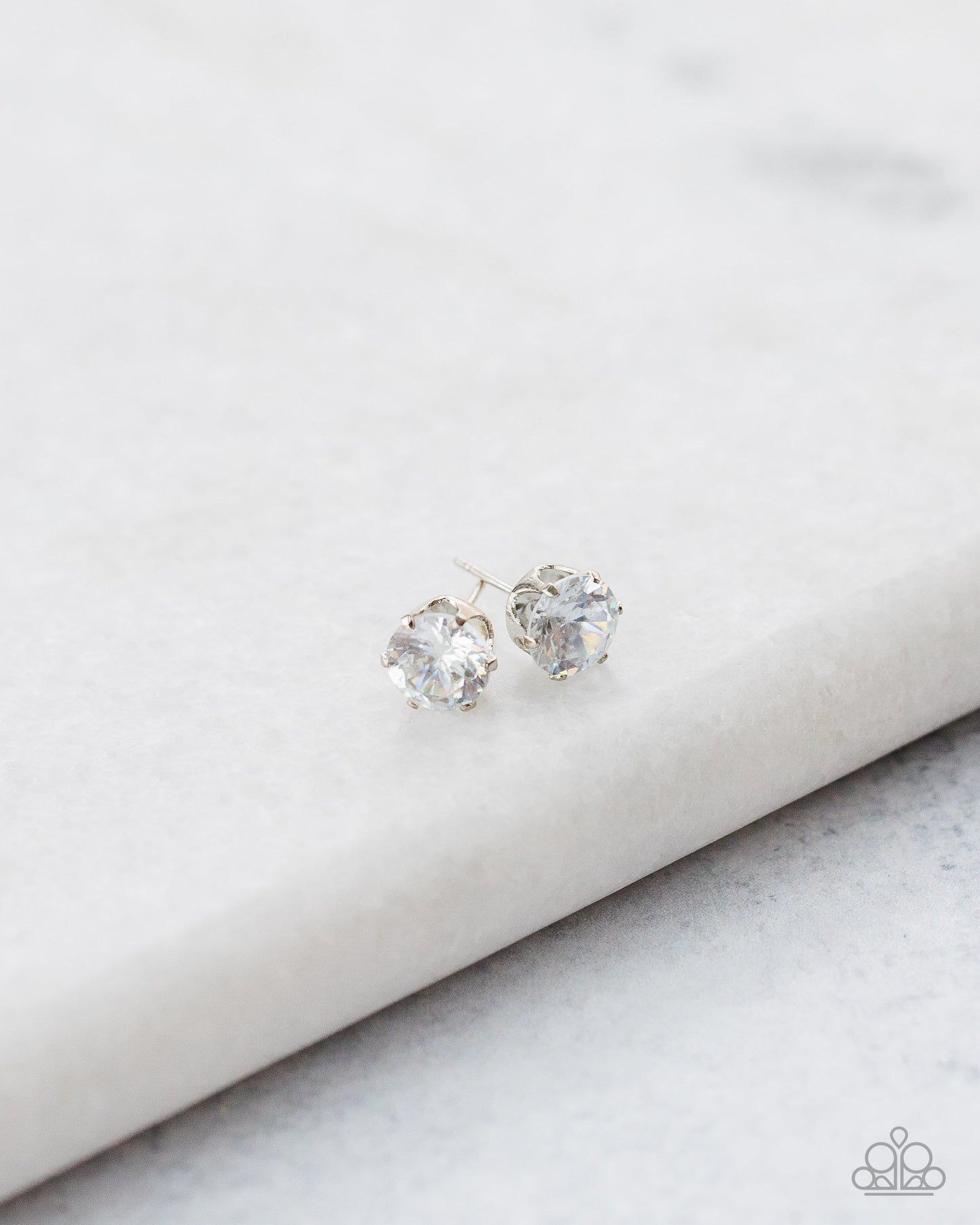 Just In TIMELESS - White and Silver Earrings - Paparazzi Accessories - A sparkling white rhinestone is nestled inside a classic silver frame for a timeless look. Earring attaches to a standard post fitting. Sold as one pair of post earrings.