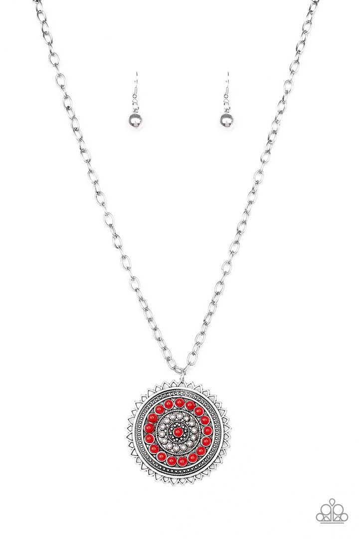 Lost SOL - Red and Silver Necklace - Paparazzi Accessories - Radiating with shimmery sunburst details, a red beaded silver pendant swings from the bottom of a lengthened silver chain for a tribal inspired style necklace.
