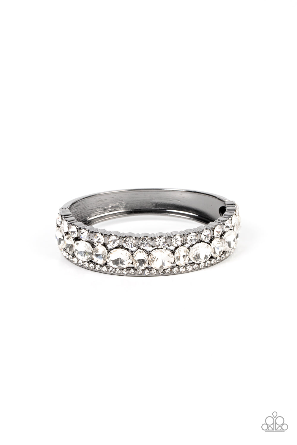 Mega Megawatt - Black Gunmetal Bracelet - Paparazzi Accessories - Bejeweled Accessories By Kristie - Three blinding rows of mismatched white rhinestones dramatically stack across the wrist, coalescing into a majestic bangle-like centerpiece. Features a hinged closure. Sold as one individual bracelet.