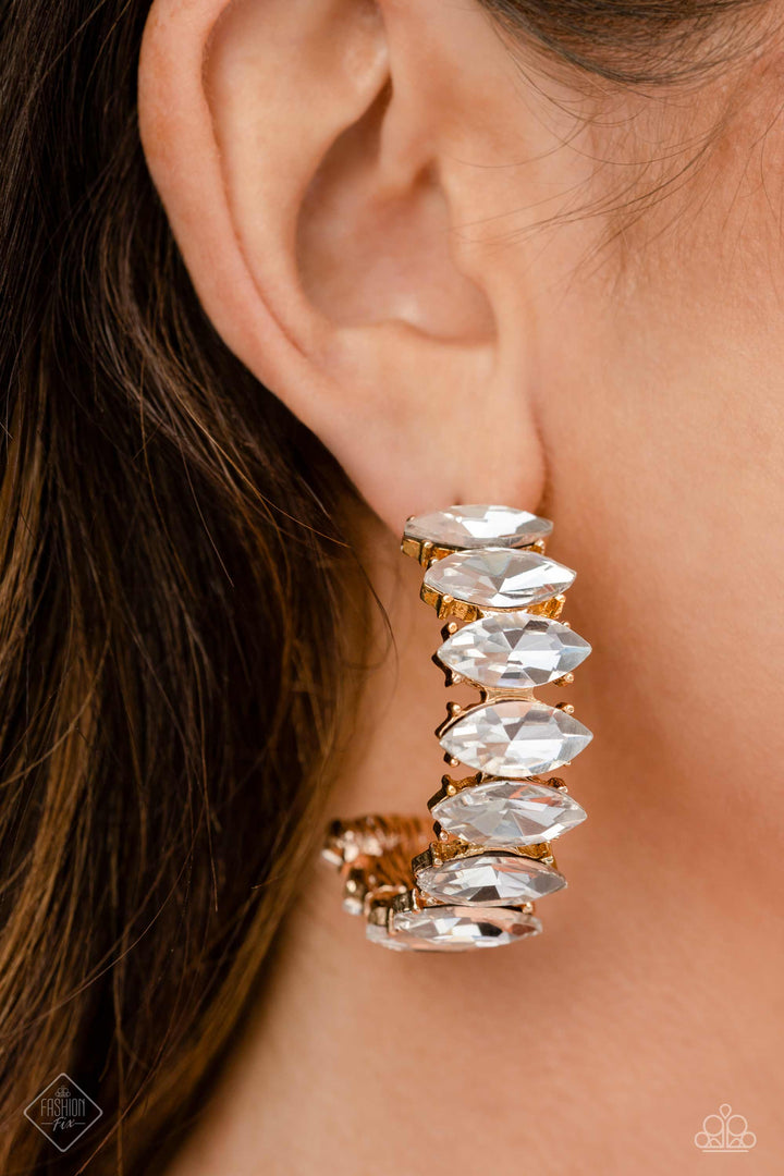 Priceless Pairing - Gold Hoop Earrings - Paparazzi Accessories - Dazzling white marquise-cut gems fall in line along the front edge of a classic gold hoop. The exposed edges create a gritty silhouette, beautifully contrasting with the blinding shimmer of the gems in a stunning finish. Earring attaches to a standard post fitting. Hoop measures approximately 1 1/2" in diameter.
