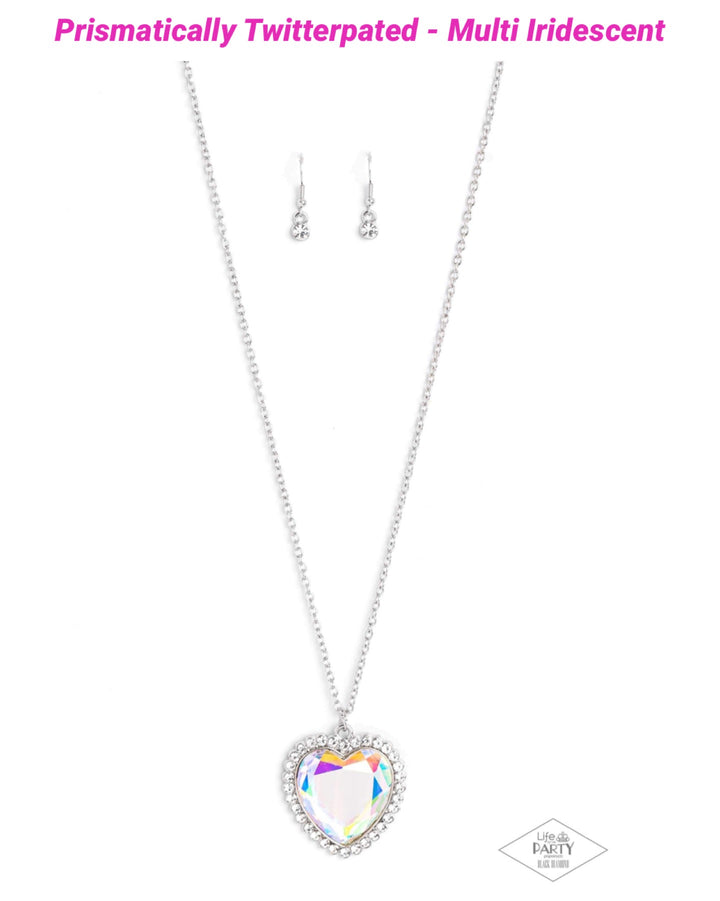 Prismatically Twitterpated - Multi Color Heart Necklace - Paparazzi Accessories - Bordered in glassy white rhinestones, an oversized iridescent heart gem sparkles from the bottom of an extended silver chain for a flirty finish. Features an adjustable clasp closure. Due to its prismatic palette, color may vary.
Sold as one individual necklace.