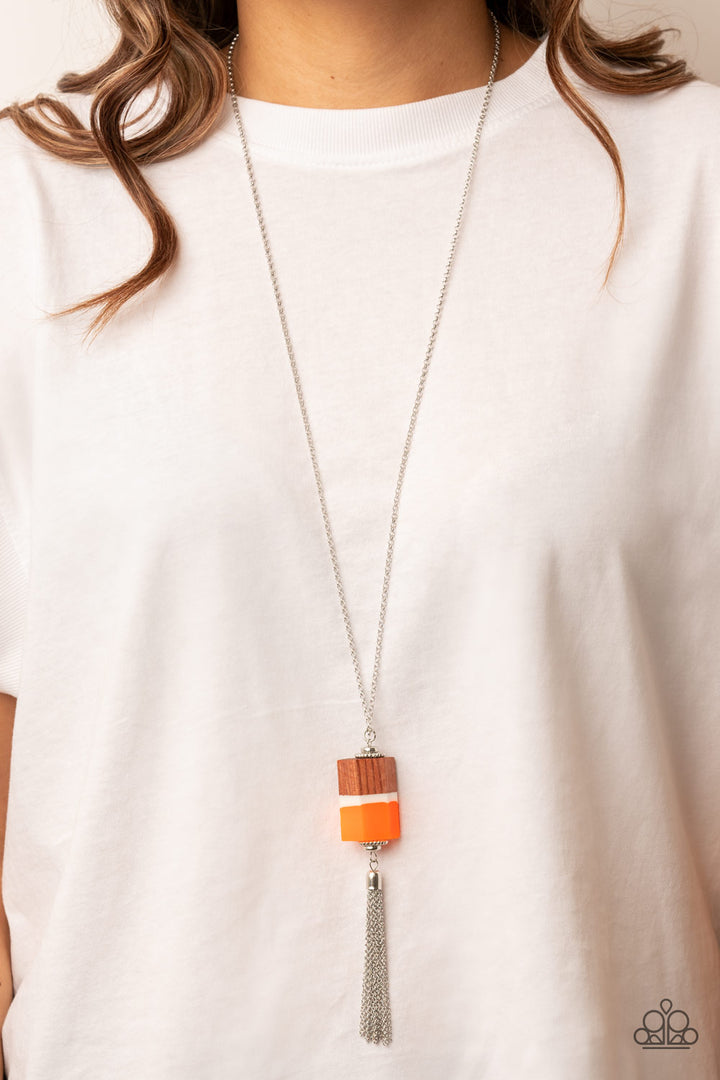 Reel It In - Orange and Silver Necklace - Paparazzi Accessories - Silver beaded accents, pieces of orange and brown wood and a white acrylic accent delicately stack into a faceted geometric pendant at the bottom of an extended silver chain. A shimmery silver chain tassel dances from the bottom of the earthy display, adding whimsical movement to the colorful piece. Features an adjustable clasp closure.