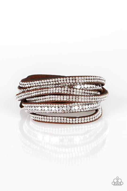 Rock Star Attitude - Brown Suede Wrap Bracelet - Paparazzi Accessories -Encrusted in rows of glassy white rhinestones and flat silver studs, three strands of brown suede wrap around the wrist for a sassy look. The elongated band allows for a trendy double wrap around the wrist. Features an adjustable snap closure.