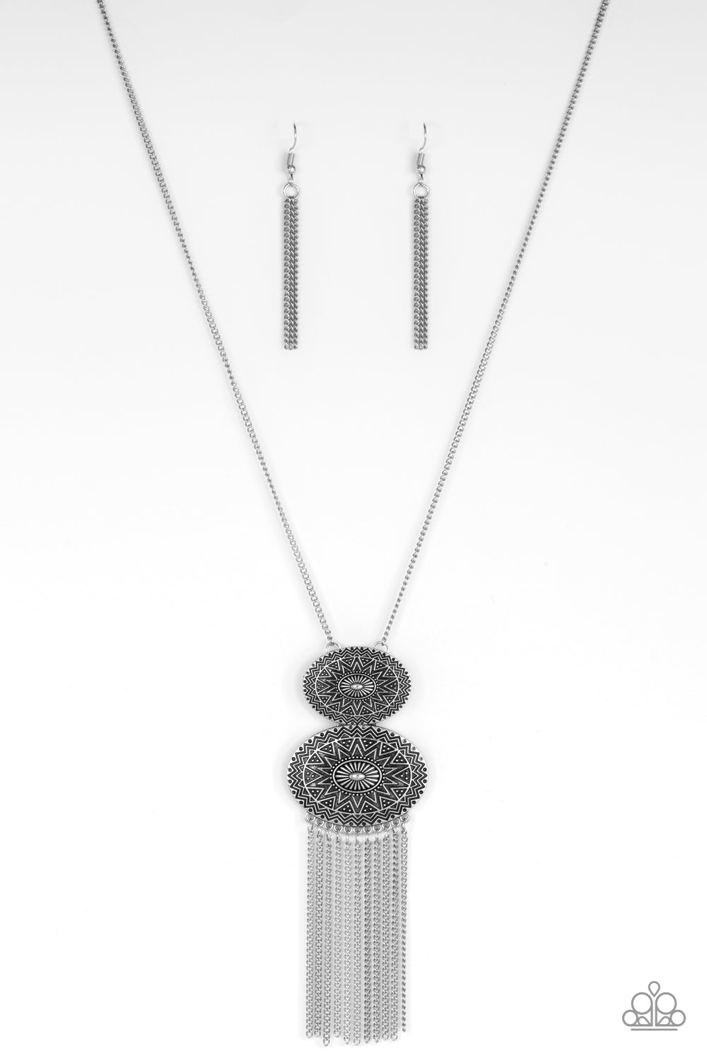 Sun Goddess - Silver Necklace - Paparazzi Accessories - Embossed in radiant sunburst patterns, two oval silver frames connect at the bottom of a lengthened silver chain. Glistening silver chains stream from the bottom of the stacked pendant, adding a wanderlust flair to the tribal inspired look. Features an adjustable clasp closure. Sold as one individual necklace.