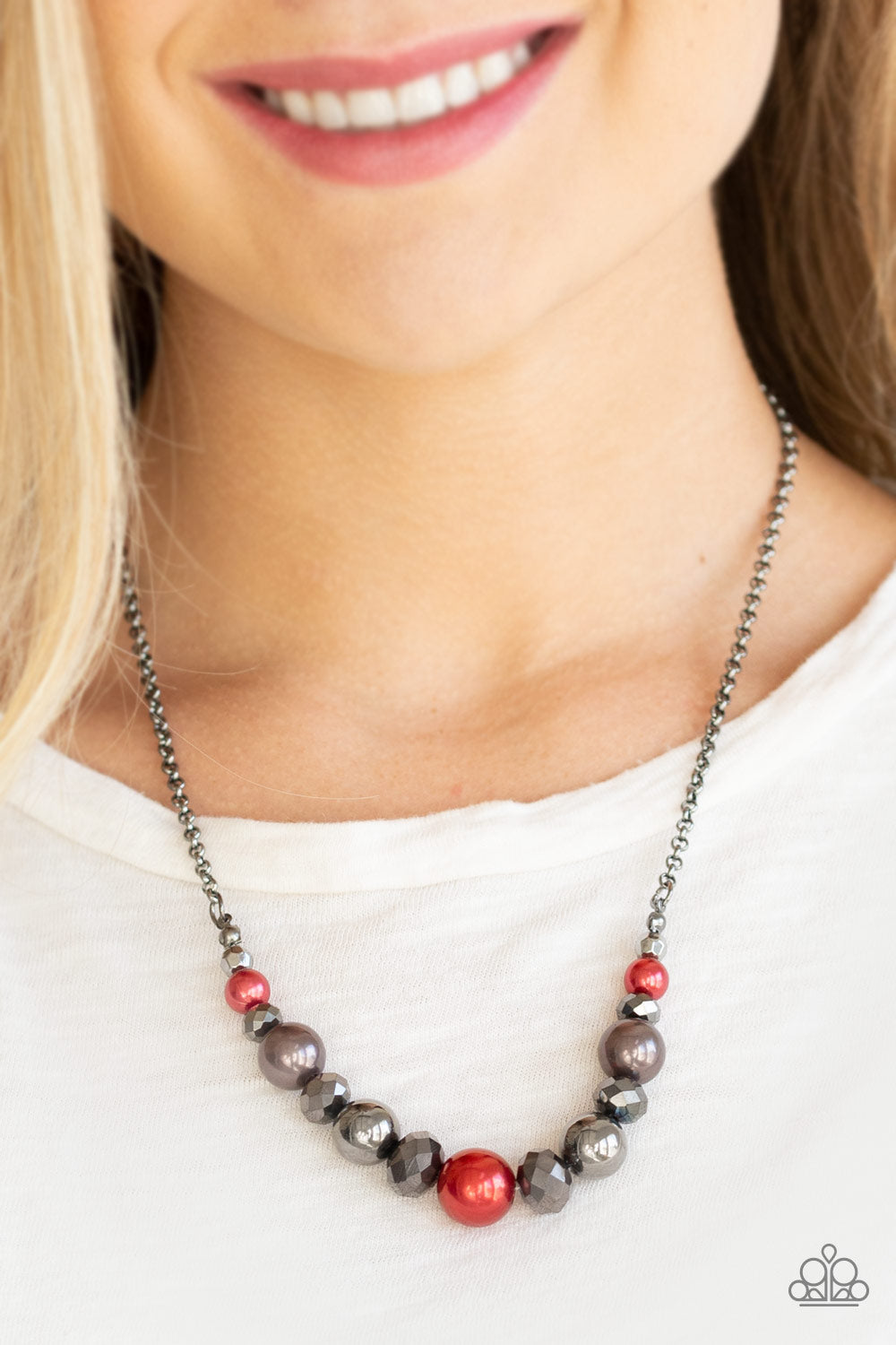 The Big-Leaguer - Red - Gunmetal Necklace - Paparazzi Accessories - A collection of pearly red, classic gunmetal, and crystal-like hematite beads are threaded along an invisible wire below the collar for a glamorous look. Features an adjustable clasp closure. Sold as one individual necklace.