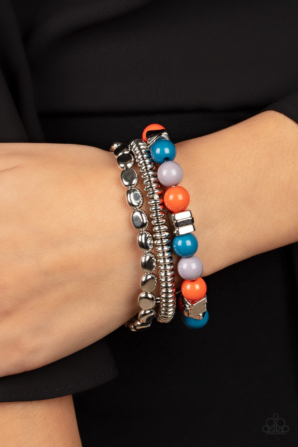 Tour de Tourist Silver Stretchy Bracelets - Paparazzi Accessories - collection of silver discs, silver cubes, bubbly multicolored acrylic, and silver pebble-like beads that are colorful with orange, blue and gray. Threaded along stretchy bands around the wrist, creating fiery layers. Sold as one set of three bracelets.