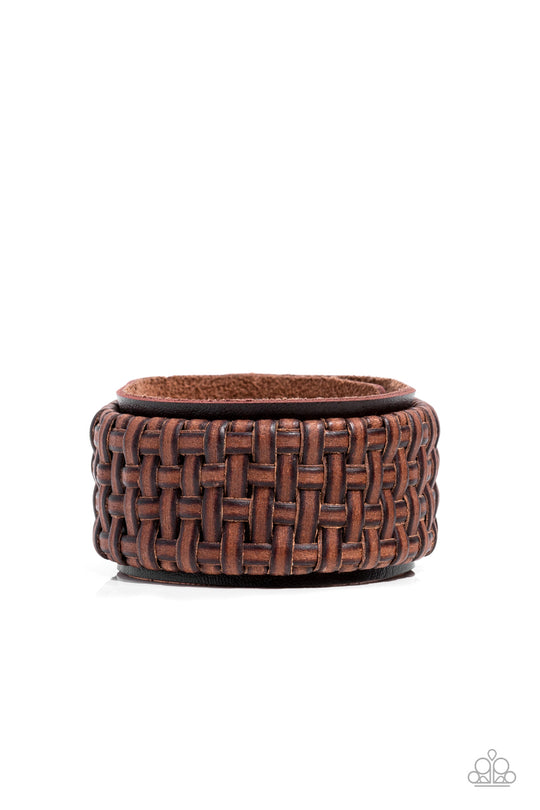 Urban Expansion Brown Leather Bracelet - Paparazzi Accessories - Bejeweled Accessories By Kristie - Distressed leather laces weave into a wicker-like pattern, creating a thick band of texture that wraps around a leather band. The textured overlay is studded in place across the front of the brown leather band, resulting in a rustic centerpiece. Features an adjustable snap closure bracelet. Trendy fashion jewelry for everyone.