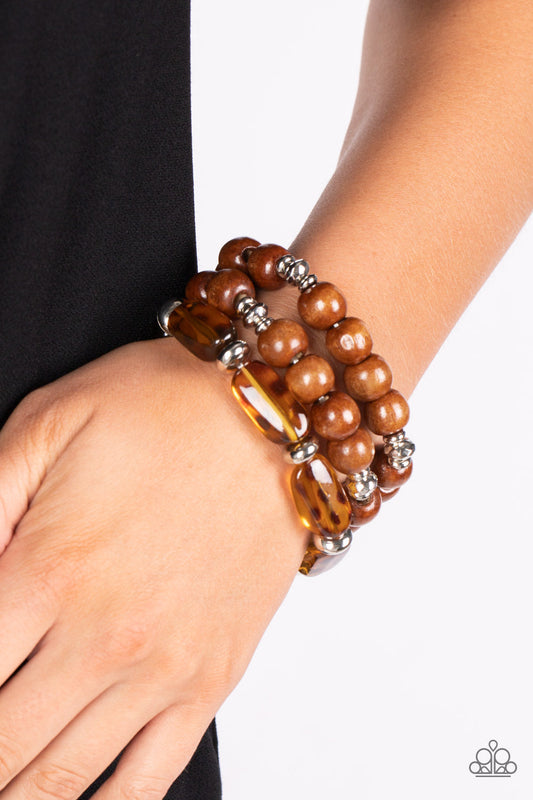 WILD-Mannered - Brown Cheetah Wood Bracelets - Paparazzi Accessories - Featuring hints of cheetah-like patterns, glassy acrylic beads join dainty silver accents and oversized wooden beads along stretchy bands that stack across the wrist in a wildly layered finish. Sold as one set of three bracelets.