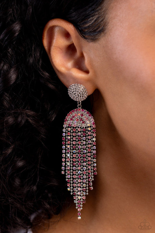 A Toast To You - Pink Iridescent Earrings - Paparazzi Accessories - Strands of various glassy pink and iridescent rhinestones and dainty silver ball chains stream from a rhinestone-encrusted arched fitting, creating a timelessly tapered fringe. Silver ball chain seemingly wraps around the post in an infinite manner above the arched fitting, creating additional tactile detail. Earring attaches to a standard post fitting.