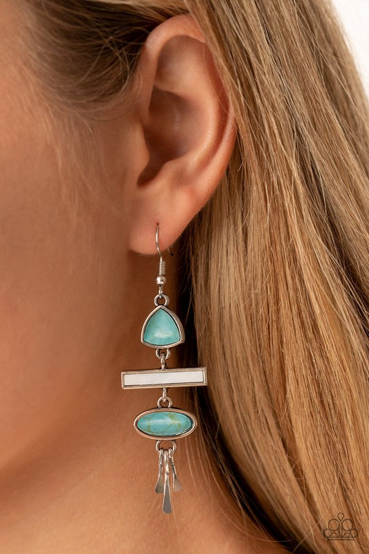 Adventurously Artisan - Blue and Silver Earrings - Paparazzi Accessories - Flared silver bars swing from the bottom of a mismatched and stacked collection of oval turquoise, flat white, and teardrop turquoise stones, resulting in an earthy lure. Earring attaches to a standard fishhook fitting. Sold as one pair of earrings.
