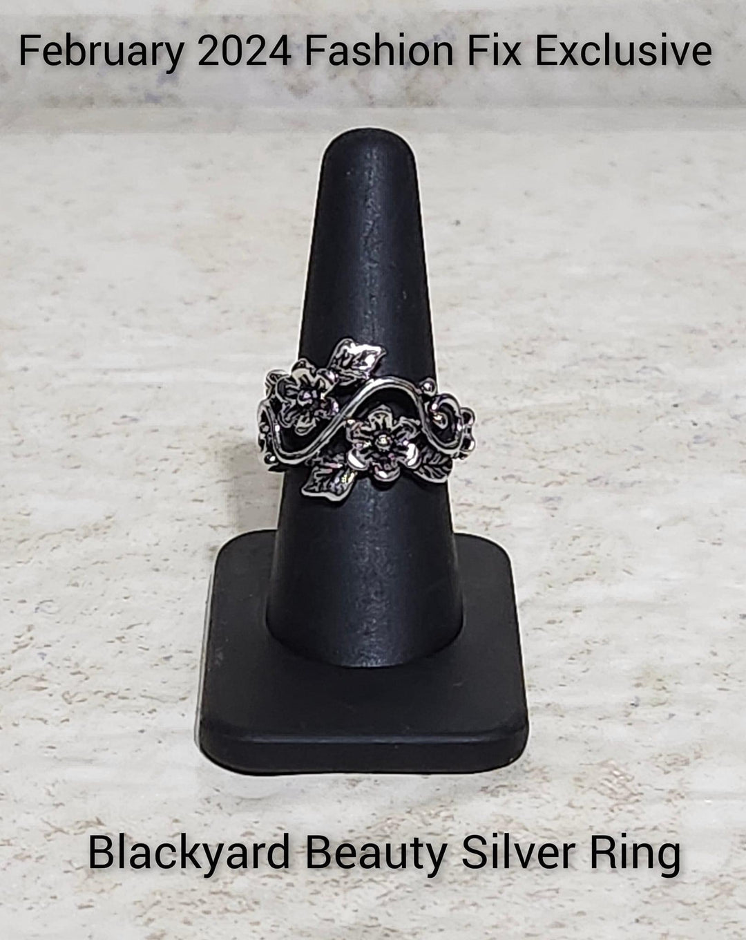 Backyard Beauty - Silver Flower Ring - Paparazzi Accessories - Brushed in an antiqued finish, leafy silver flowers and leaves bloom across the finger on an airy silver vine for a seasonal look. Features a dainty stretchy band for a flexible fit. Sold as one individual ring.