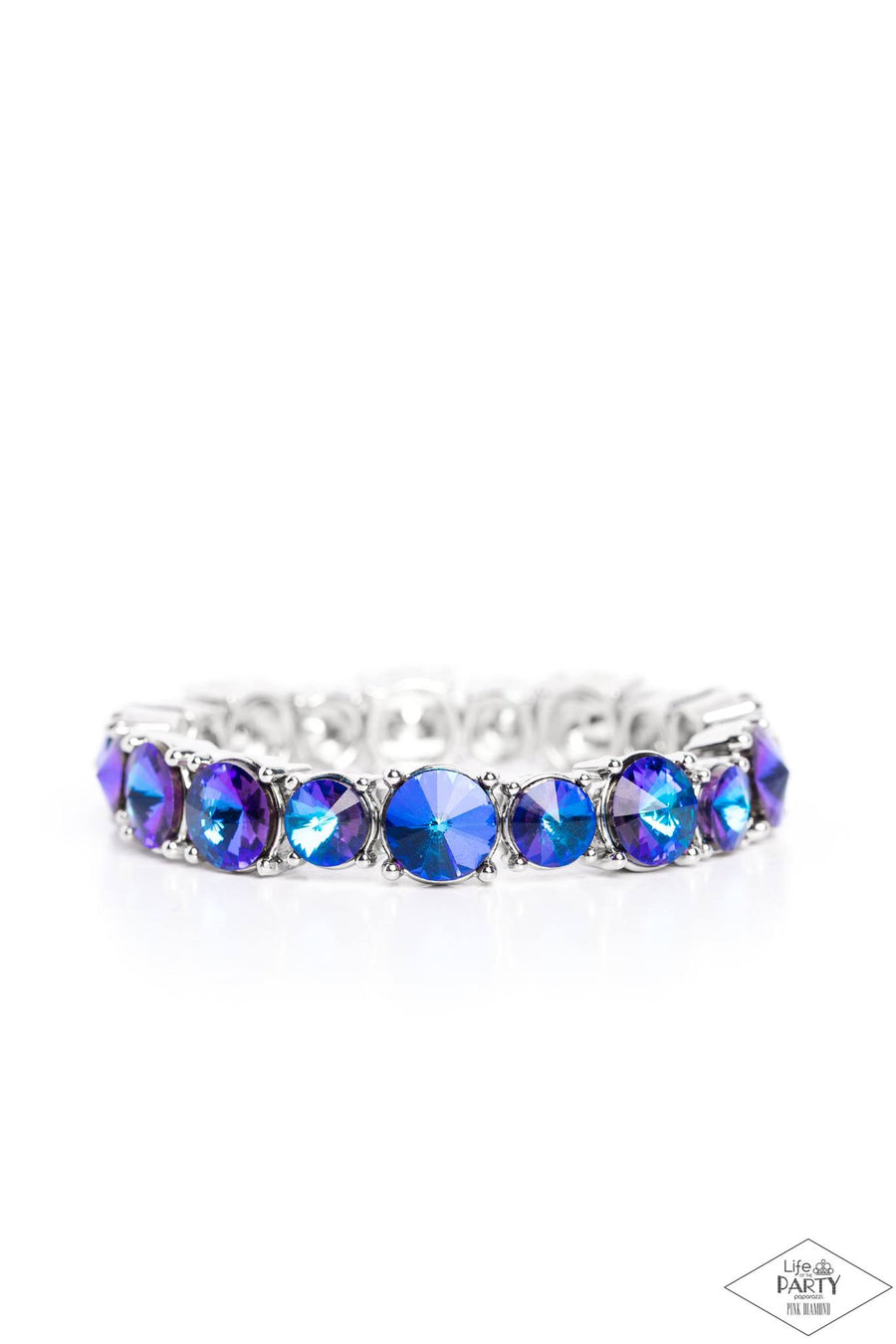 Born to Bedazzle - Blue Oil Spill Bracelet - Paparazzi Accessories - An assortment of oversized blue oil spill rhinestones are pressed into silver frames and threaded along stretchy bands, creating a blinding sparkle around the wrist. Sold as one individual bracelet.