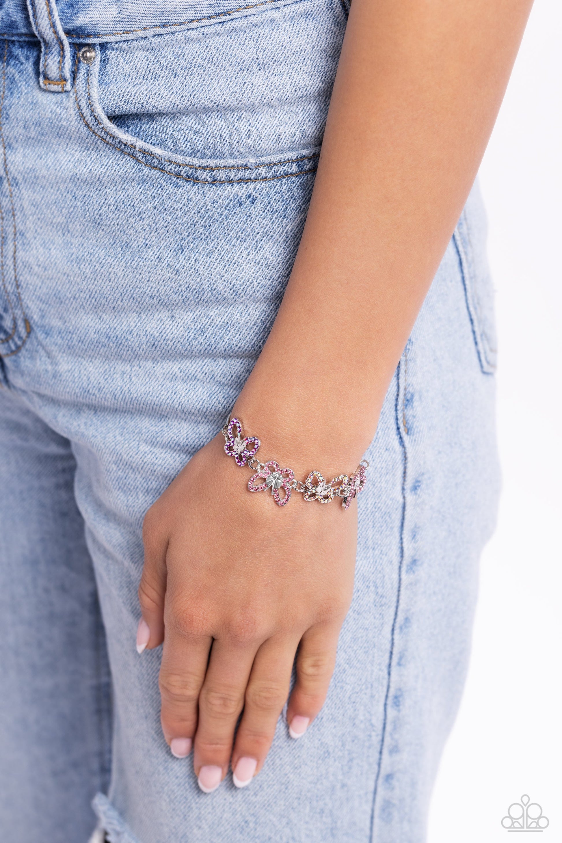 Butterfly Belonging - Pink Bracelet - Paparazzi Accessories - Attached to a silver snake chain, a whimsical collection of multicolored pink and iridescent-dotted silver butterflies flutter along the wrist.